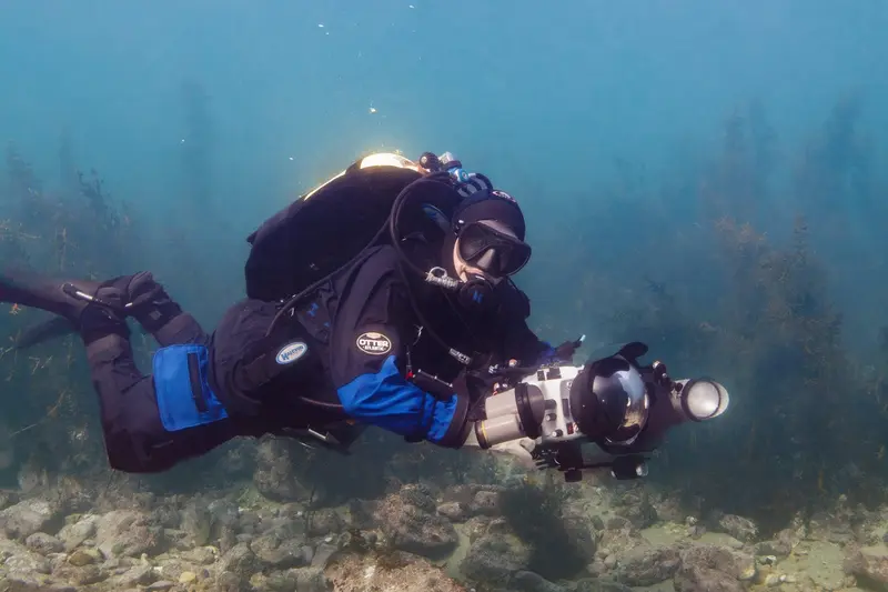 Sophie Mormede scuba diving with an underwater camera